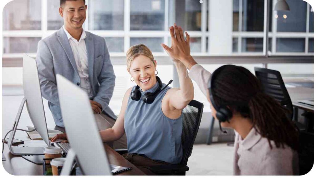 a group of people in an office raising their hands